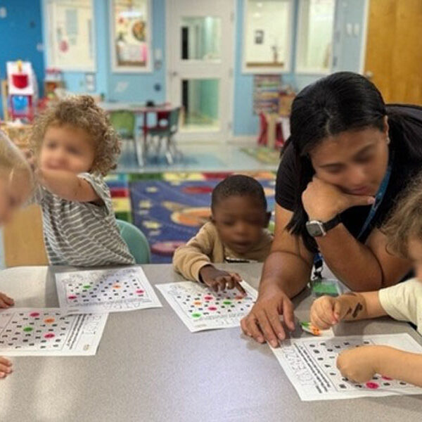 Teacher working with TOP TOTS Learning Center Children
